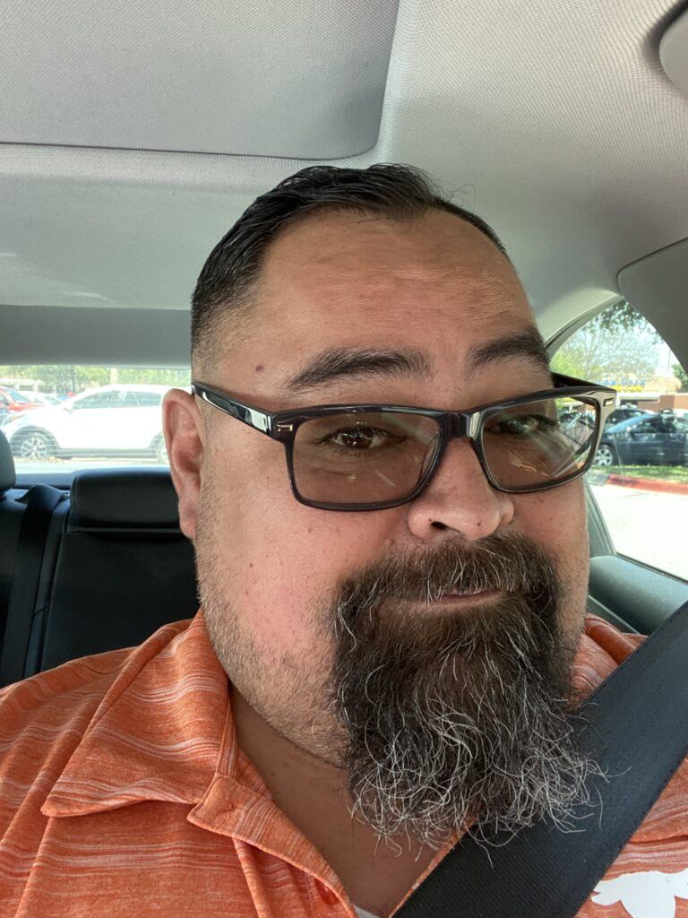 Michael Gray in his car on the way to a tailgate party