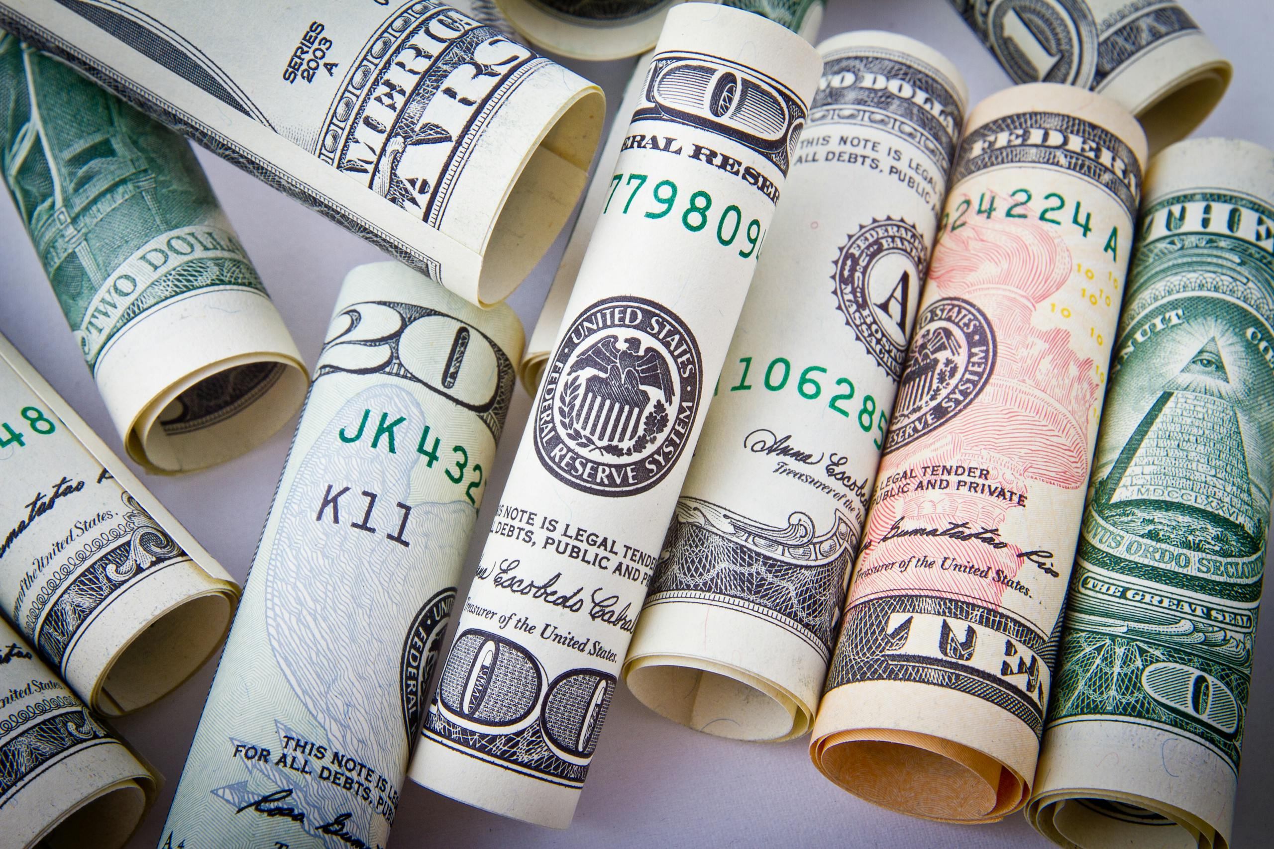 Close-up of rolled US dollar bills symbolizing wealth, financial success, and currency. Make Money With Wealthy Affiliate